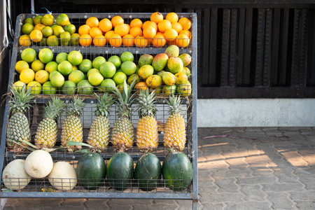 Fresh pineapple, watermelon, mango, papaya and orange on a market stall in India, tropical fruit, beach of Kochi, Indiaの写真素材