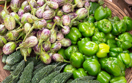 Fresh vegetables, grocery market in India, sale stall on street with green peppers, eggplants and...