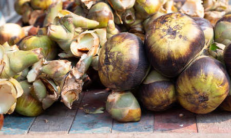 Fresh toddy palm fruit on a market stall in India, tropical fruit, Asian palmyraの写真素材