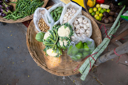 Fresh vegetables, grocery market in India, sale stall on street with garlic, cauliflower, papaya and peanuts, Indian cultureの写真素材