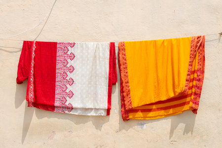 Clothes hanging for to dry on the clothesline, old aged house facade, lifestyle and culture, decaying wallの写真素材