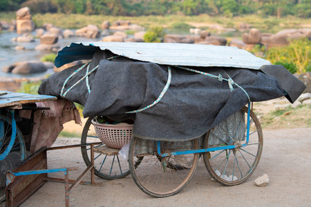 Market stall hand cart standing on a street in India, traditional wagon for transportation and sale covered with a tarpaulinの写真素材