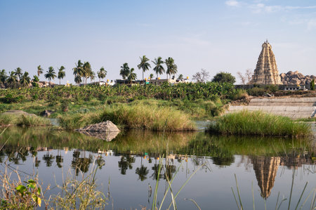 Tungabhadra river with view over the historic city of Hampi with the Virupaksha temple, South India, ancient Vijayanagara Empireの写真素材