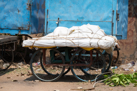 Market stall hand cart standing on a street in India, traditional wagon for transportation and sale covered with a tarpaulinの写真素材