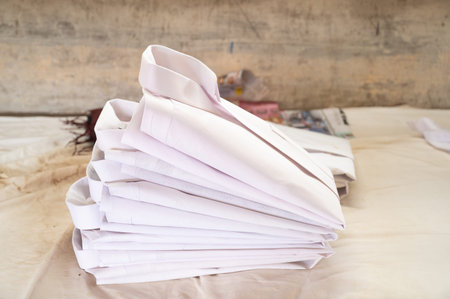 Pile of freshly ironed white business shirts, Dhobi Ghat, open air laundry in Kochi, India