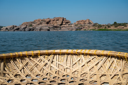 Coracle boats on the Tungabhadra River in Hampi, India, traditional round fishing basket boat made from cane, leather and bitumenの写真素材