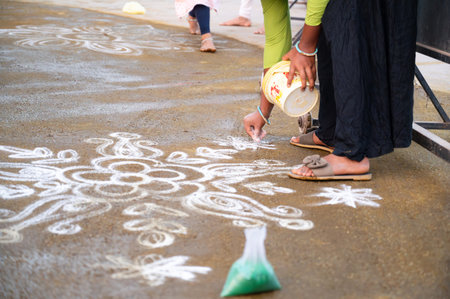 Kolam, colorful sand painting with rice powder drawn by women and girls at the evening of Holi festival in India, Indian religion and culture, Hinduism celebrationの写真素材