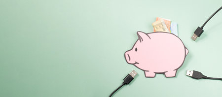 Expensive electricity, energy bill, power generation shortage, increase price, inflation, electric cable and piggy bank, economics and financial crisisの写真素材