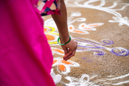 Kolam Rangoli, colorful sand painting drawing women and girls at the evening of Holi festival in India, Indian religion and culture, Hinduism celebrationの写真素材