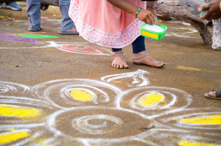 Kolam Rangoli, colorful sand painting drawing women and girls at the evening of Holi festival in India, Indian religion and culture, Hinduism celebrationの写真素材
