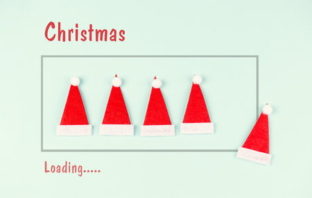 Christmas loading progress bar, red Santa Claus hat in a row, countdown of winter holiday season, greeting cardの写真素材