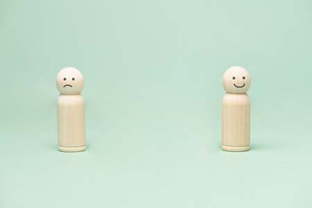 Sad and happy smiling face, mental health, attitude, positive and negative mind, influence emotion, support and depression, different mindsetの写真素材