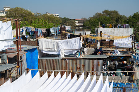 Dhobi Ghat, open air laundry in Mumbai, India, cleaned clothes hanging on clothes line to dry, washing bed sheets and linenの写真素材