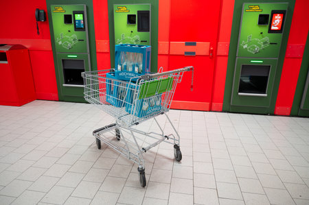 Deposit bottles in shopping cart, reverse vending machine for returning beverage containers subject to recycling system, Trier, Germany, November 17th 2025のeditorial素材