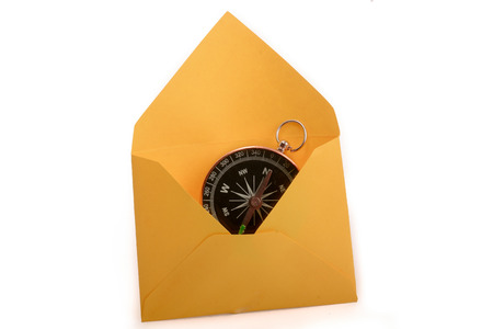 Compass in a an envelope on a white backgroundの写真素材