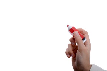 Isolated thick, red pencil in hand on a white backgroundの写真素材