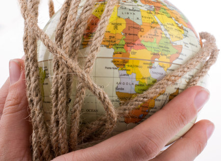 hands holding the globe wrapped in rope