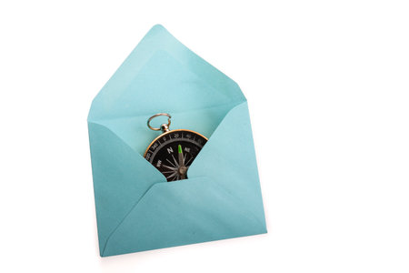 Compass in a an envelope on a white background