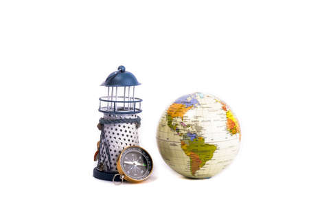 lighthouse, globe and compass side by side on a white backgroundの写真素材