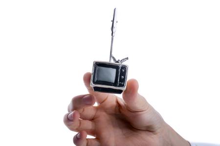 Child holding a tv set n his hand on a white backgroundの写真素材