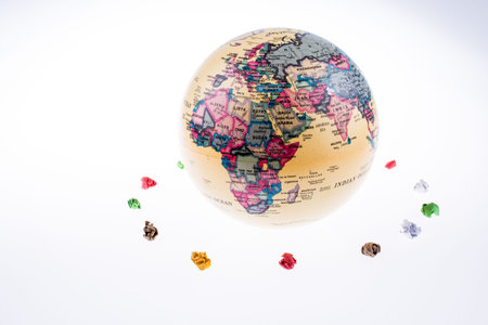 globe orbit and crumpled papers on a white backgroundの写真素材