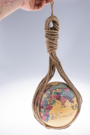 globe hanging in rope on white backgroundの写真素材