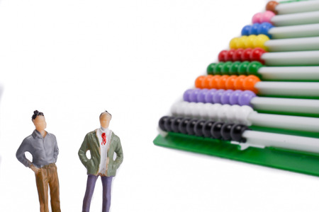 Two man standing by the colorful abacus on a white backgroundの写真素材