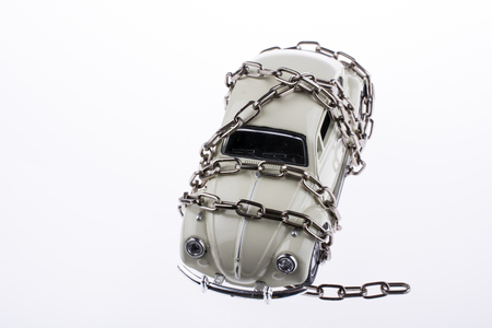 Chained white car on white backgroundの写真素材