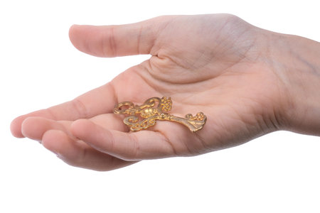 hand holding a  retro styled metal key  on a white backgroundの写真素材