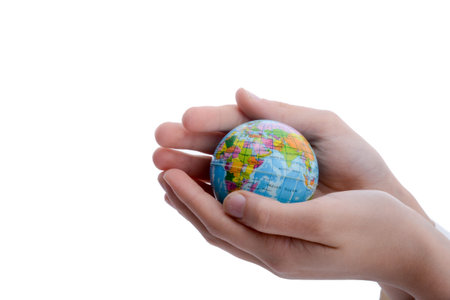 Child holding a small globe in hand on white background