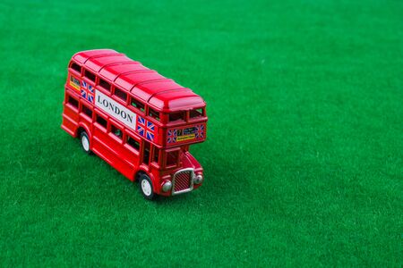 Red london bus on green grassの写真素材