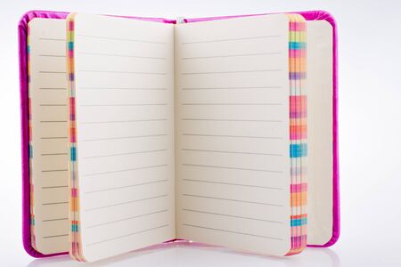 Pink notebook on a white backgroundの写真素材