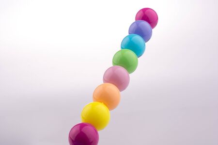 Color beads with facial expression on white backgroundの写真素材