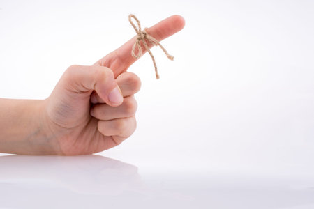 Hand tied with a thread like a ribbon on a white background