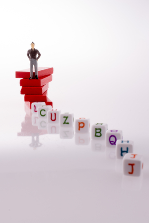 Man and alphabet blocks on a white backgroundの写真素材