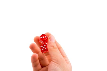 Hand holding red dice on a white backgroundの写真素材