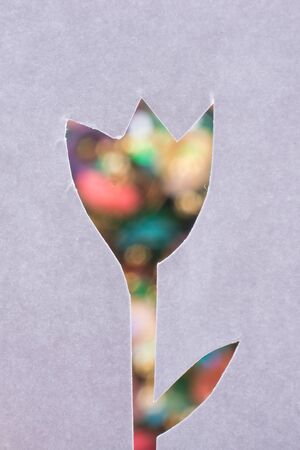 Tulip shape cut out of a paper with a colorful backgroundの写真素材