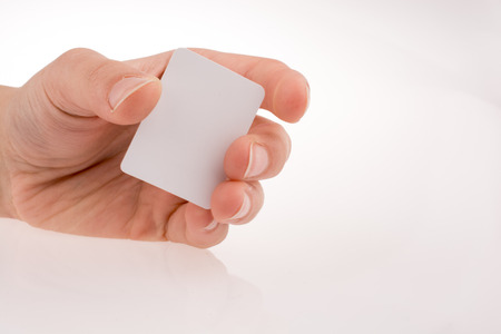 Hand holding a piece of paper on a white backgroundの写真素材