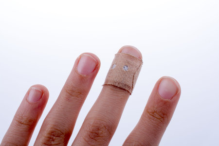 finger in white bandage on a white background