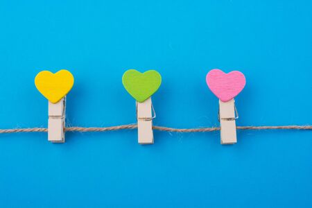 Colorful hearted clips on a blue backgroundの写真素材