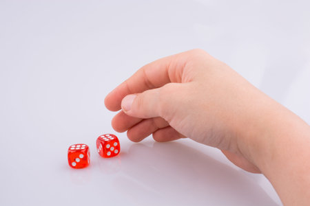 Hand holding red dice on a white background