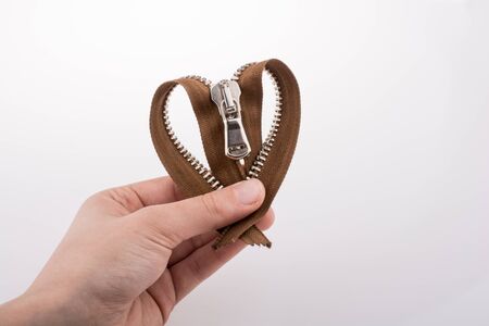 Heart shaped zipper on a white backgroundの写真素材