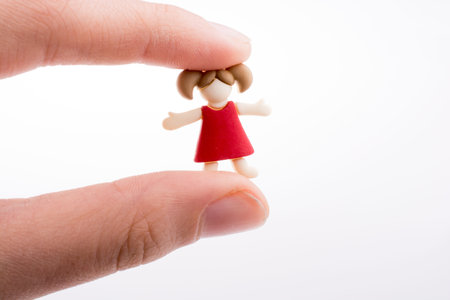 Hand holding a child figure on a white background
