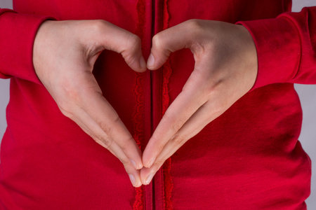 Hand making a heart on a white background