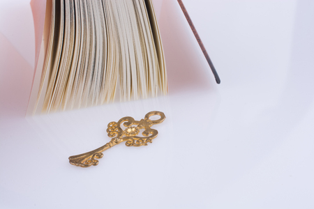 Key near the Holy Quran on a white backgroundの写真素材