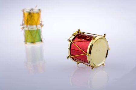 Little colorful toy drums  on a white backgroundの写真素材