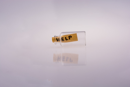 Help word on a piece paper in aglass  bottleの写真素材