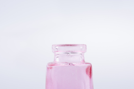 Little colorful empty  glass bottle on a white backgroundの写真素材