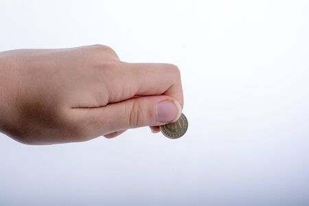 Hand handing money on a white bakgroundの写真素材