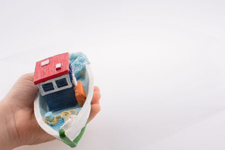 Little colorful model boat with windows on white background
